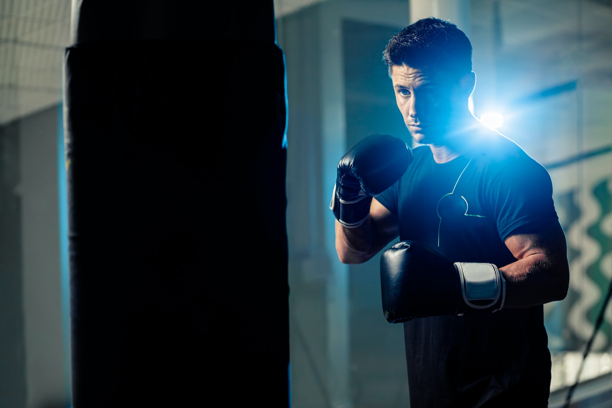 muscular handsome boxing man fighter with boxing bag